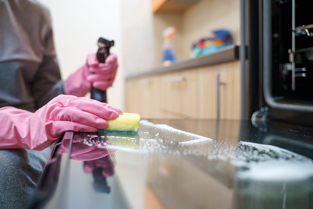 Person cleaning an oven