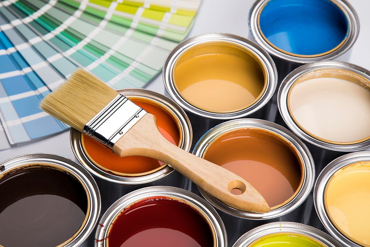 Paint brush and various open paint cans