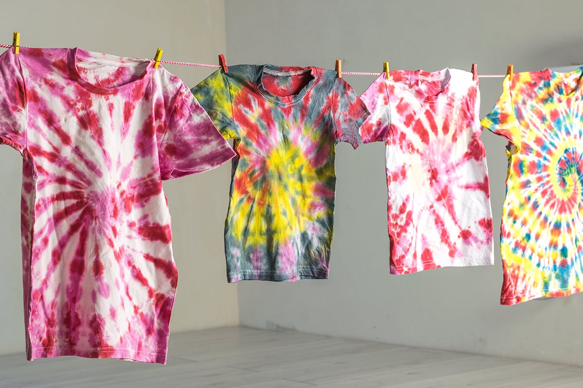 T-shirts painted in tie dye style drying